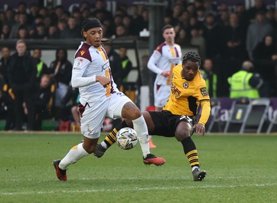 150225  Newport County v Bradford City, EFL Sky Bet League 2 - Geoffroy Bony of Newport County is brought down by Tommy Leigh of Bradford City