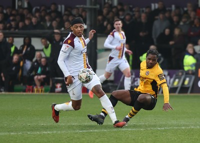 150225  Newport County v Bradford City, EFL Sky Bet League 2 - Geoffroy Bony of Newport County is brought down by Tommy Leigh of Bradford City