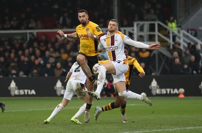 150225  Newport County v Bradford City, EFL Sky Bet League 2 - Courtney Baker-Richardson of Newport County is challenged by Aden Baldwin of Bradford City as he looks to shoot