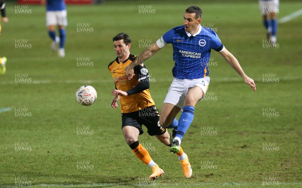 100121 - Newport County v Brighton and Hove Albion, FA Cup Third Round - Padraig Amond of Newport County and Lewis Dunk of Brighton compete for the ball