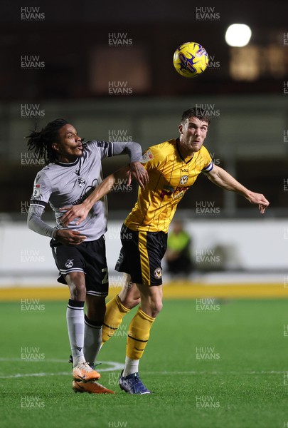 141123 - Newport County v Bristol Rovers, Bristol Street Motors EFL Trophy - Ryan Delaney of Newport County heads the ball forward as Jevani Brown of Bristol Rovers challenges