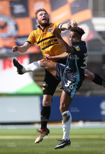 190419 - Newport County v Bury FC - SkyBet League Two - Mark O'Brien of Newport County and Nicky Maynard of Bury go up for the ball