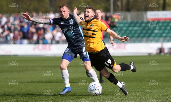 190419 - Newport County v Bury FC - SkyBet League Two - Ben Kennedy of Newport County is tackled by Nicky Adams of Bury