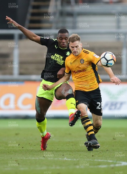 031217 - Newport County v Cambridge United, FA Cup Second Round - Mickey Demetriou of Newport County is challenged by Uche Ikpeazu of Cambridge United