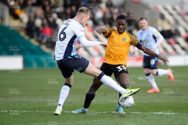080220 - Newport County v Cambridge United - Sky Bet League 2 -   Jordan Green of Newport County is tackled by Harry Darling of Cambridge United 