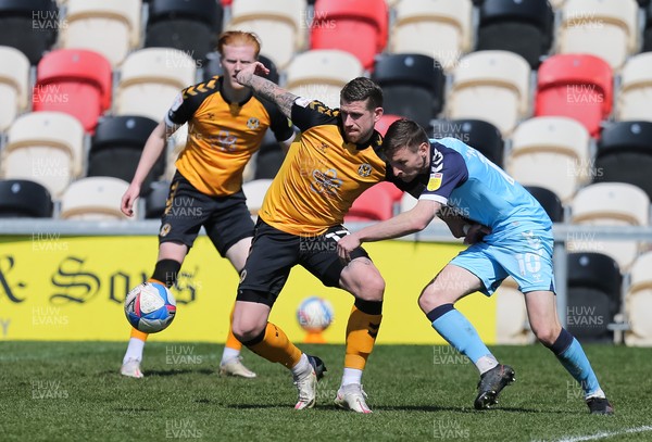170421 Newport County v Cambridge United, Sky Bet League 2 - Scot Bennett of Newport County and Paul Mullin of Cambridge United compete for the ball