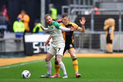 210226 - Newport County v Cambridge United - Sky Bet League 2 - James Brophy of Cambridge United holds off Sven Sprangler of Newport County 