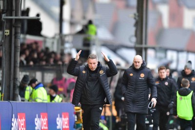 210226 - Newport County v Cambridge United - Sky Bet League 2 - Cambridge head coach Neil Harris does The Ayatollah towards the fans as he goes in for half time