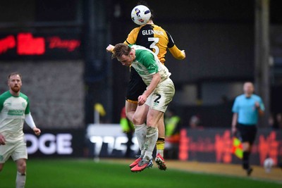 210226 - Newport County v Cambridge United - Sky Bet League 2 - Anthony Driscoll-Glennon of Newport County wins the header above Liam Bennett of Cambridge United 