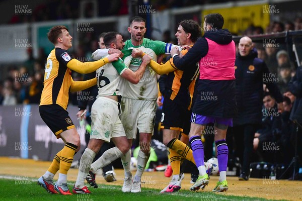 210226 - Newport County v Cambridge United - Sky Bet League 2 - A confrontation between James Gibbons of Cambridge United and Harrison Biggins of Newport County is broken up by teammates