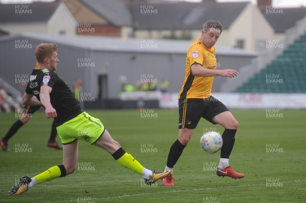 280418 - Newport County v Cambridge United - Sky Bet League 2 - Matty Dolan of Newport County is tackled by David Halliday of Cambridge United