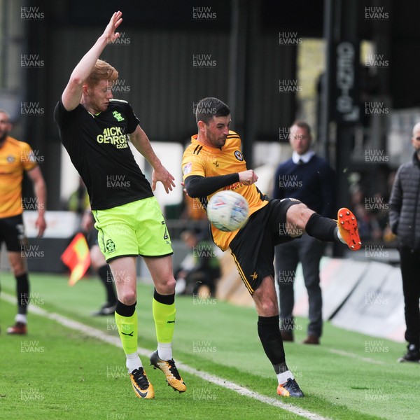 280418 - Newport County v Cambridge United - Sky Bet League 2 - Padraig Amond of Newport County keeps the ball in under pressure from David Halliday of Cambridge United