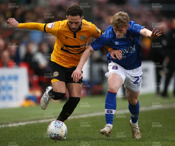 020319 - Newport County v Carlisle United - SkyBet League Two - Robbie Willmott of Newport County is challenged by Liam McCarron of Carlisle United
