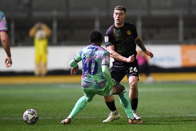 110225 - Newport County v Carlisle United - Sky Bet League 2 - Cameron Evans of Newport County is challenged by Kadeem Harris of Carlisle United 