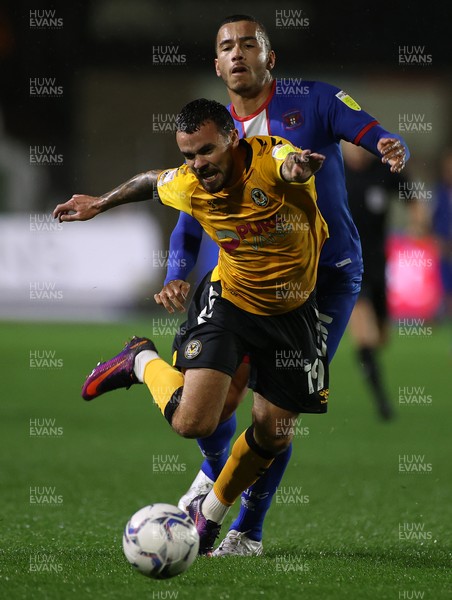 191021 - Newport County v Carlisle United - SkyBet League Two - Dom Telford of Newport County is tackled by Rod McDonald of Carlisle