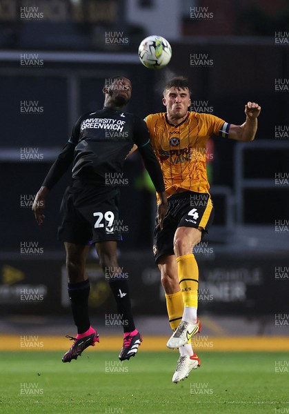 080823 - Newport County v Charlton Athletic - Carabao Cup - Daniel Kanu of Charlton Athletic and Ryan Delaney of Newport County go up for the ball