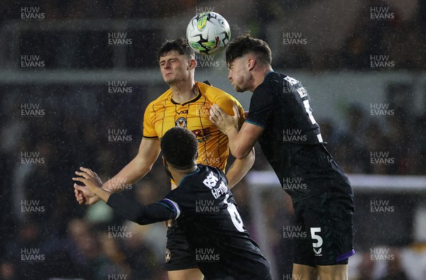 080823 - Newport County v Charlton Athletic - Carabao Cup - Seb Palmer-Houlden of Newport County and Lucas Ness of Charlton Athletic go up for the ball
