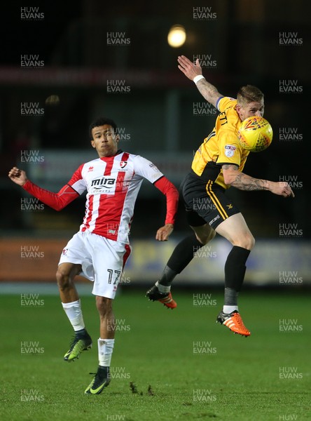 071117 - Newport County v Cheltenham Town - Checkatrade Trophy - Scot Bennett of Newport County gets the ball away from Jerell Sellars of Cheltenham Town