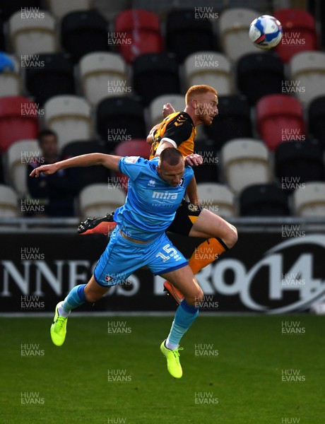 080920 - Newport County v Cheltenham Town - EFL Trophy - Ryan Taylor of Newport County and William Boyle of Cheltenham Town compete in the air