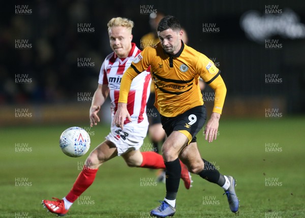 150319 - Newport County v Cheltenham Town, SkyBet League 2 - Padraig Amond of Newport County gets past Ryan Broom of Cheltenham Town to shoot at goal