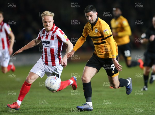 150319 - Newport County v Cheltenham Town, SkyBet League 2 - Padraig Amond of Newport County gets past Ryan Broom of Cheltenham Town to shoot at goal