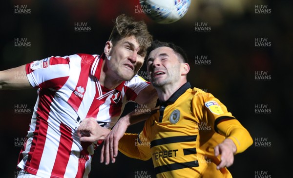 150319 - Newport County v Cheltenham Town, SkyBet League 2 - Padraig Amond of Newport County and Charlie Raglan of Cheltenham Town compete for the ball 