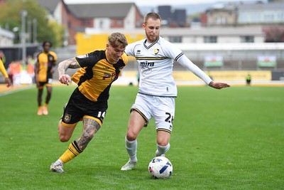 181025 - Newport County v Cheltenham Town - Sky Bet League 2 - Kai Whitmore of Newport County is challenged by Ben Stevenson of Cheltenham Town