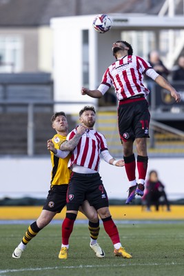 220225 - Newport County v Cheltenham Town - Sky Bet League 2 - James Clarke of Newport County in action against Matty Taylor of Cheltenham Town