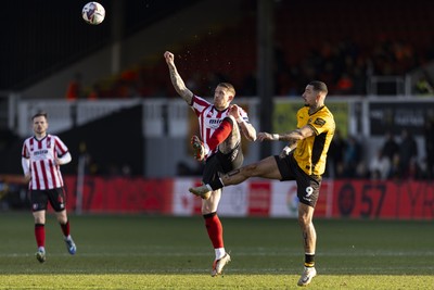 220225 - Newport County v Cheltenham Town - Sky Bet League 2 - Scot Bennett of Cheltenham Town in action against Courtney Baker-Richardson of Newport County