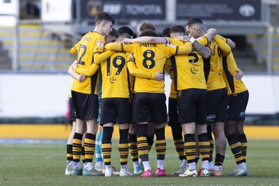 220225 - Newport County v Cheltenham Town - Sky Bet League 2 - Jaden Warner of Newport County huddle ahead of kick off