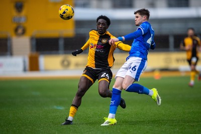 240126 - Newport County v Chesterfield - Sky Bet League 2 - Tom Pearce of Chesterfield beats Nathaniel Opoku of Newport County