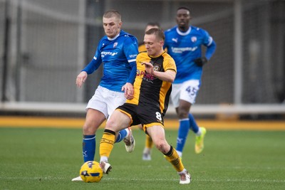 240126 - Newport County v Chesterfield - Sky Bet League 2 - Matthew Smith of Newport County holds off Ryan Stirk of Chesterfield