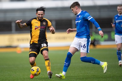 240126 - Newport County v Chesterfield - Sky Bet League 2 - Liam Shephard of Newport County is tackled by Tom Pearce of Chesterfield