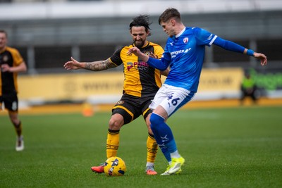 240126 - Newport County v Chesterfield - Sky Bet League 2 - Liam Shephard of Newport County is tackled by Tom Pearce of Chesterfield
