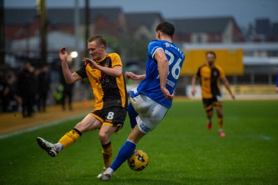 240126 - Newport County v Chesterfield - Sky Bet League 2 - Sil Swinkles of Chesterfield clears under pressure from Matthew Smith of Newport County