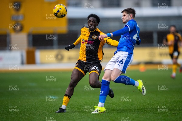 240126 - Newport County v Chesterfield - Sky Bet League 2 - Tom Pearce of Chesterfield beats Nathaniel Opoku of Newport County