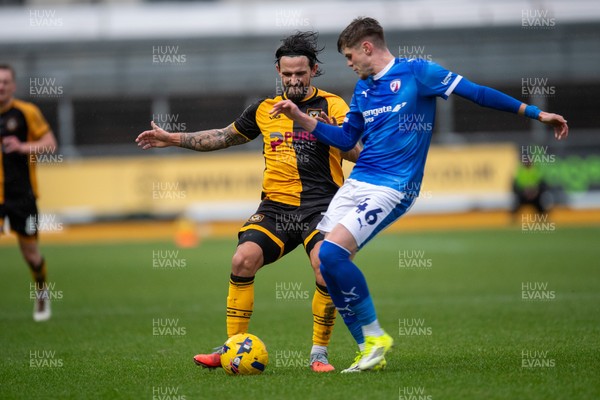 240126 - Newport County v Chesterfield - Sky Bet League 2 - Liam Shephard of Newport County is tackled by Tom Pearce of Chesterfield