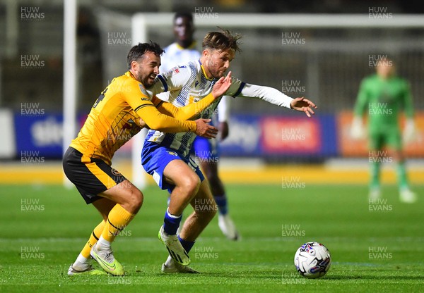 031023 - Newport County v Colchester United - EFL SkyBet League 2 - Aaron Wildig of Newport County and Noah Chilvers of Colchester United compete