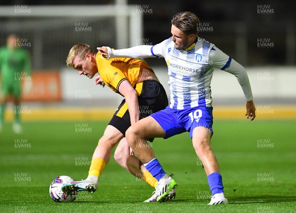 031023 - Newport County v Colchester United - EFL SkyBet League 2 - Will Evans of Newport County and Noah Chilvers of Colchester United compete