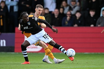 101026 - Newport County v Colchester United - Sky Bet League 2 - Ciaran Brennan of Newport County is challenged by Moses Sesay of Colchester