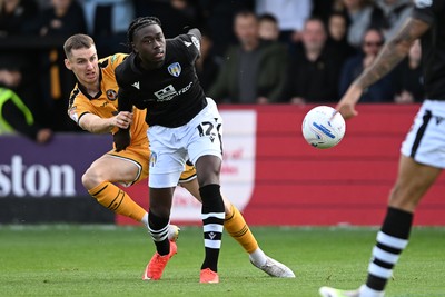 101026 - Newport County v Colchester United - Sky Bet League 2 - Ciaran Brennan of Newport County is challenged by Moses Sesay of Colchester