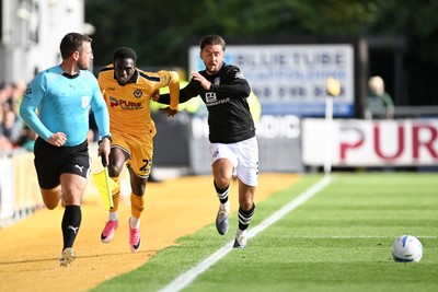101026 - Newport County v Colchester United - Sky Bet League 2 - Michael Adu-Poku of Newport County is challenged by Ellis Iandolo of Colchester