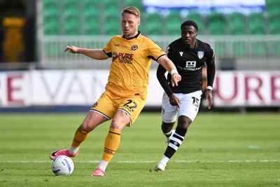 101026 - Newport County v Colchester United - Sky Bet League 2 - Cameron Norman of Newport County is challenged by Beryly Lubala of Colchester