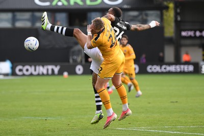 101026 - Newport County v Colchester United - Sky Bet League 2 - Cameron Norman of Newport County is challenged by Jay Williams of Colchester