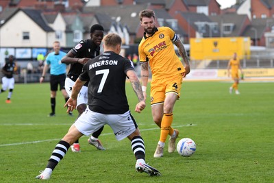 101026 - Newport County v Colchester United - Sky Bet League 2 - Kyle Cameron of Newport County is challenged by Harry Anderson of Colchester