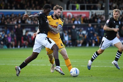 101026 - Newport County v Colchester United - Sky Bet League 2 - Kyle Cameron of Newport County is challenged by Sam Kuffour of Colchester