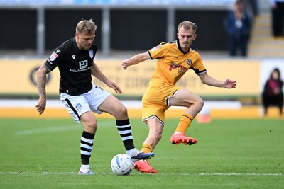 101026 - Newport County v Colchester United - Sky Bet League 2 - Matty Jacob of Newport County is challenged by Harry Anderson of Colchester