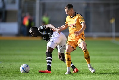 101026 - Newport County v Colchester United - Sky Bet League 2 - Ciaran Brennan of Newport County is challenged by Moses Sesay of Colchester