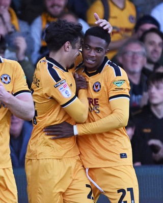 101026 - Newport County v Colchester United - Sky Bet League 2 - Tanatswa Nyakuhwa of Newport County celebrates scoring a goal with team mates