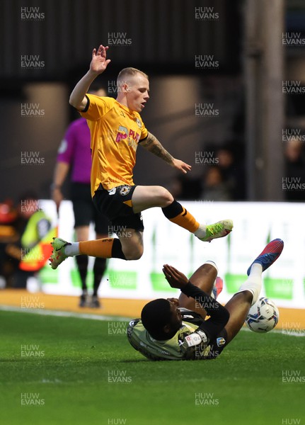 220422 - Newport County v Colchester United, Sky Bet League 2 - James Waite of Newport County avoids the challenge from Junior Tchamadeu of Colchester United